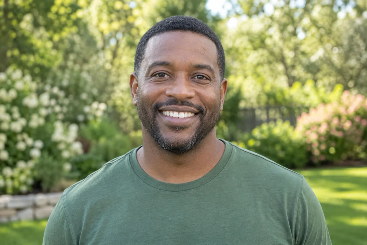 Man smiling at the camera outdoors